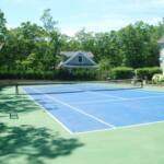All Weather Court Blue Inside Green Outside Brick Retaining Wall and Chain Link Fencing